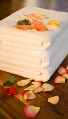 Room service towels surrounded by flower petals